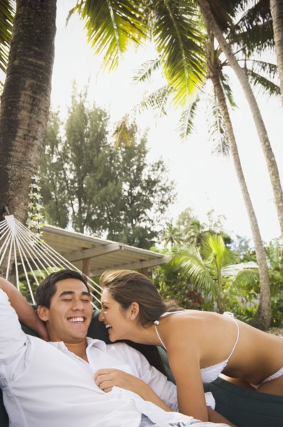 Multi-ethnic couple laughing on beach