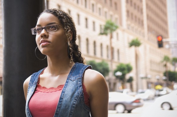 African woman standing on sidewalk