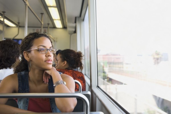 African woman riding on train
