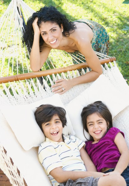 Mother and children relaxing in hammock