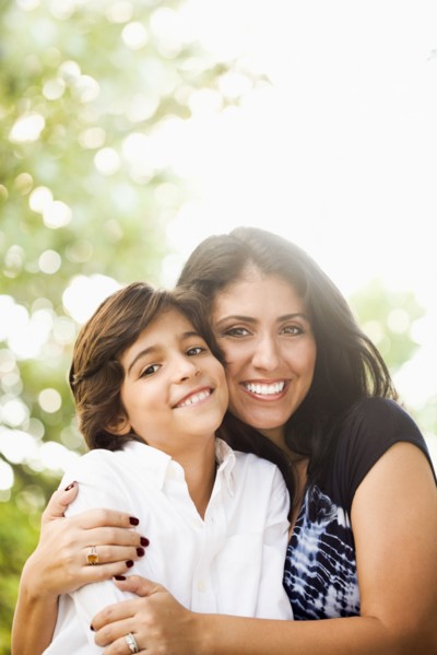 Mixed race mother hugging son