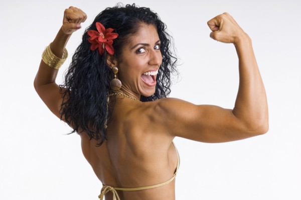 Mixed race woman body builder flexing muscles