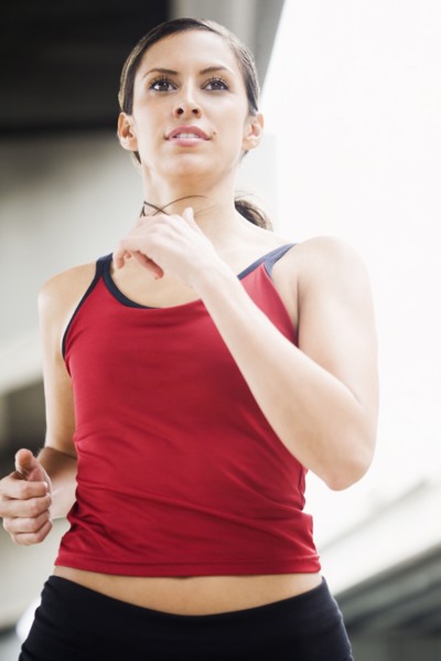 Hispanic woman running in urban area