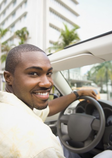 African American man driving convertible