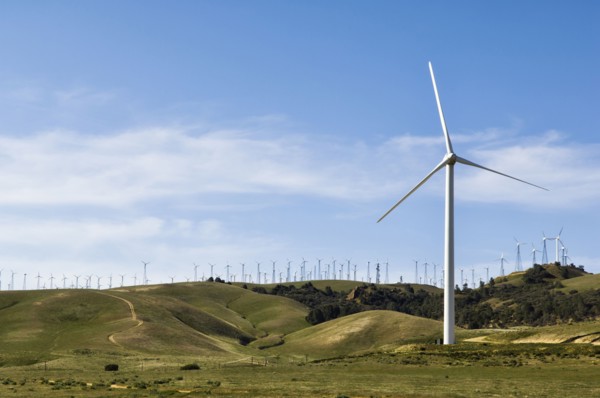 Wind turbines lining hilltop in rolling landscape