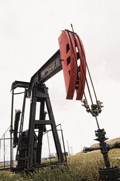 Pump working in oil field in remote landscape