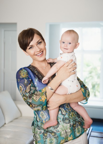 Caucasian mother holding baby in living room