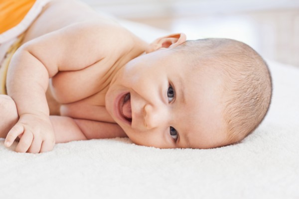 Mixed race baby laying on blanket