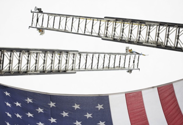 Low angle view of crane ladders and American flag