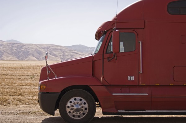 Red semi-truck against mountains