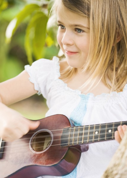 Caucasian girl playing ukulele