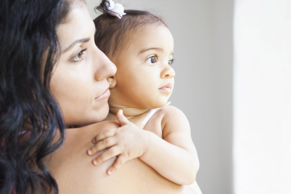 Mixed Race mother holding baby daughter