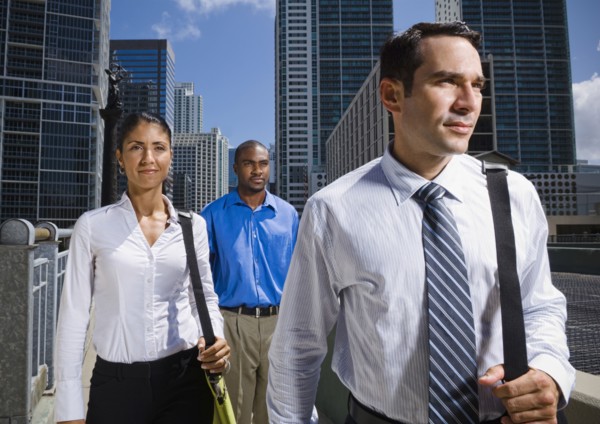 Serious business people walking in city