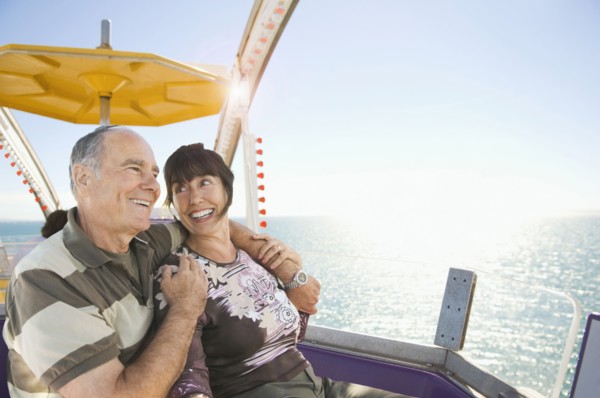 Senior couple sitting near ocean
