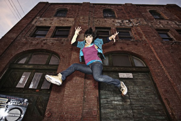Chinese woman breakdancing in urban area