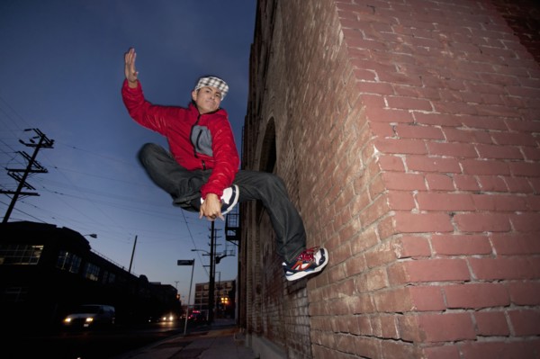 Pacific Islander man breakdancing in urban area