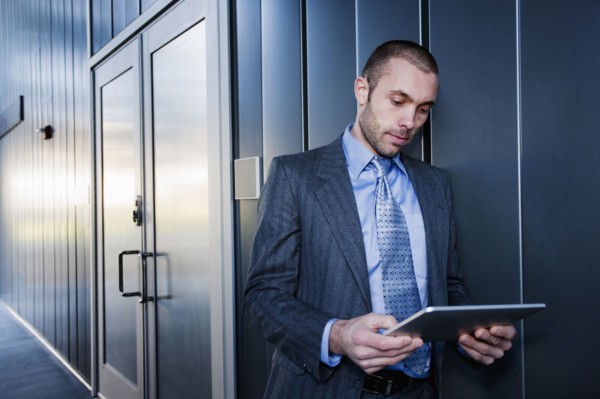 Businessman using digital tablet outdoors