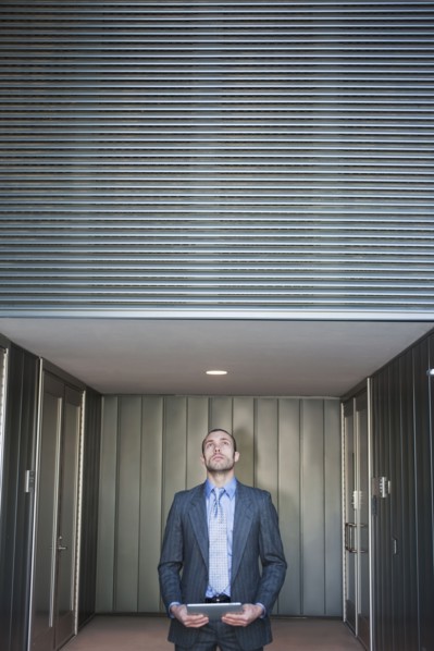 Businessman using digital tablet in corridor