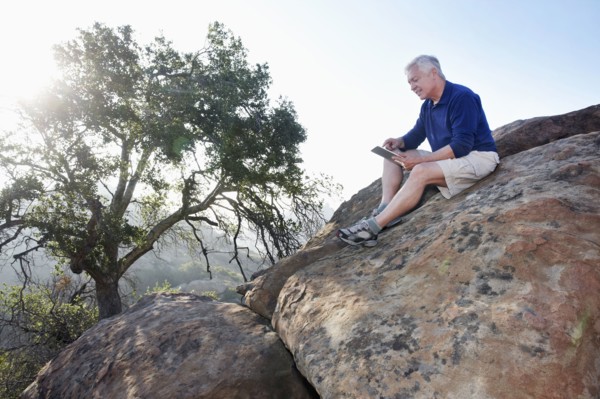 Caucasian man using digital tablet in remote area