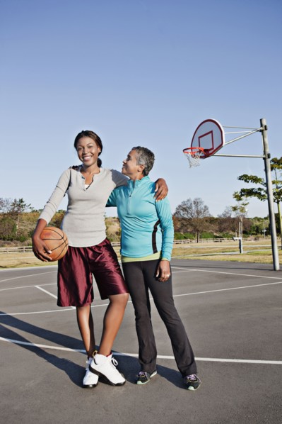 Mother and daughter playing basketball