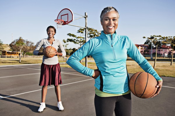Mother and daughter playing basketball