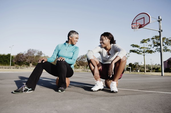 Mother and daughter playing basketball