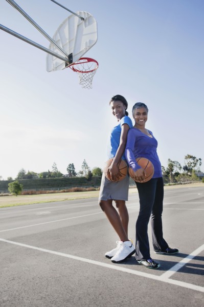 Mother and daughter playing basketball