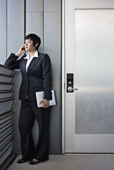 Businesswoman talking on cell phone and holding digital tablet