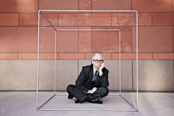 Caucasian businessman sitting inside of box