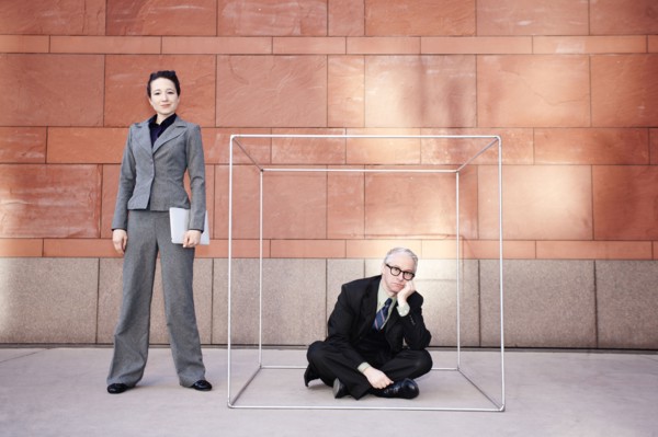 Businesswoman standing next to co-worker in box