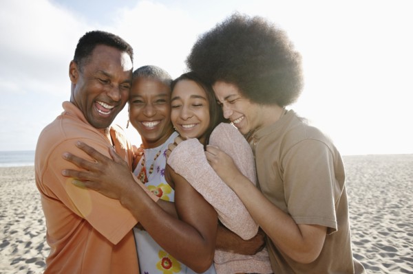 Family hugging on beach