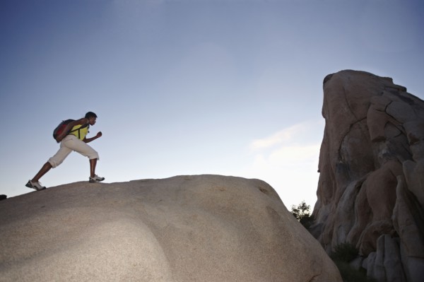 Woman hiking on large rock