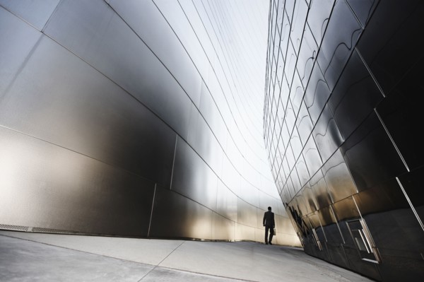Businessman walking in urban alley