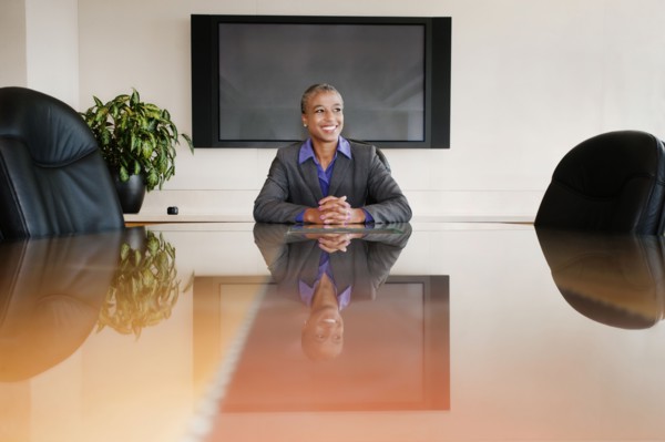 Black businesswoman sitting in empty conference room