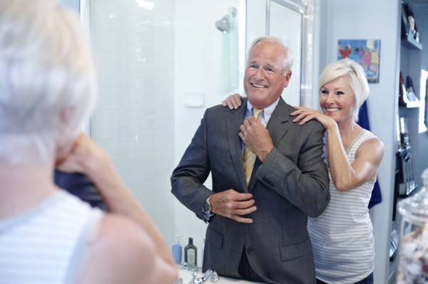 Caucasian couple dressing in bathroom
