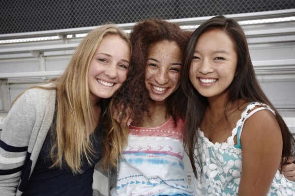 School friends sitting together on bleachers