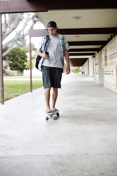 Caucasian teenager riding skateboard