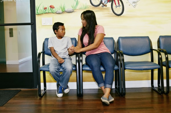 Mixed race boy and mother in waiting room