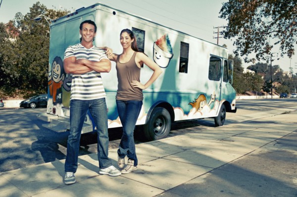Couple standing by ice cream truck