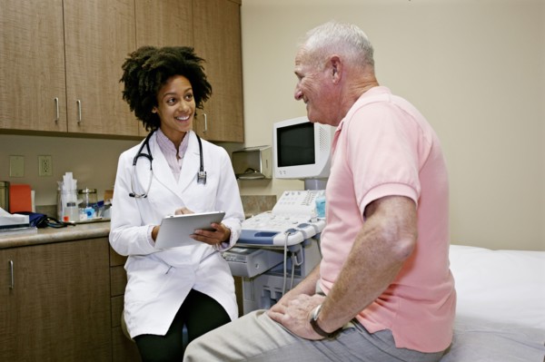 Doctor talking to patient in office