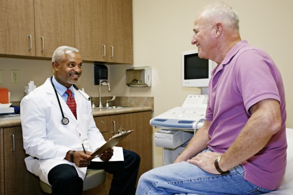 Doctor talking to patient in office