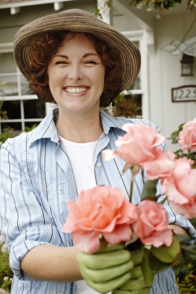 Smiling woman working in garden
