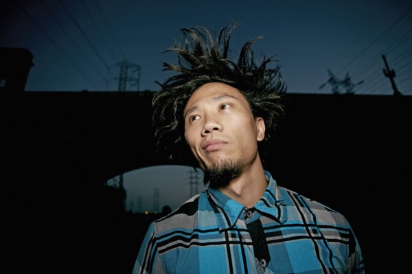 Asian man standing under overpass