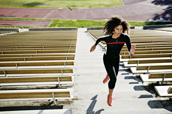 Mixed race runner training in stadium