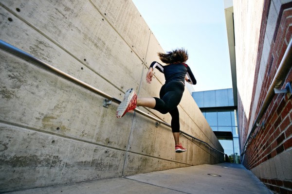 Mixed race runner training in stadium