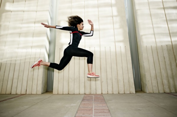 Mixed race woman running on city street