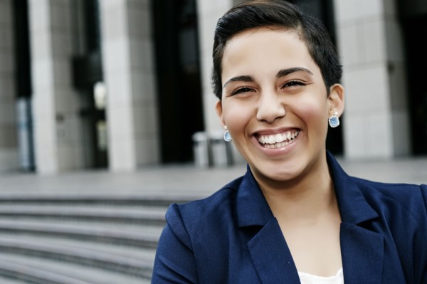 Hispanic businesswoman laughing outdoors