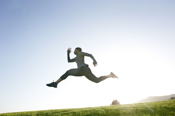 Black woman running in rural landscape