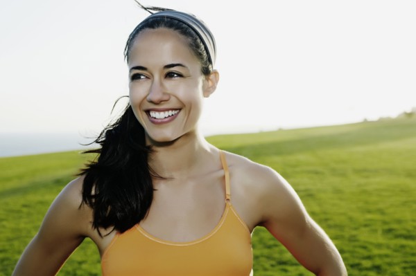 Hispanic woman smiling in field