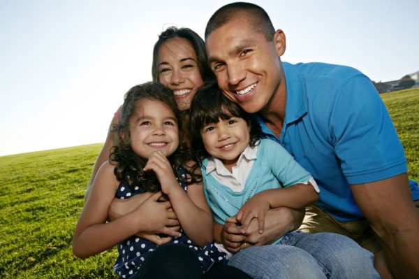Family smiling together in field